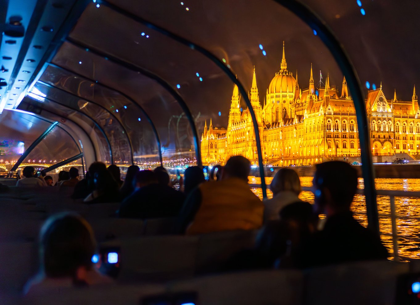 Budapest evening sightseeing cruise with illuminated Parliament Building viewed from the Danube